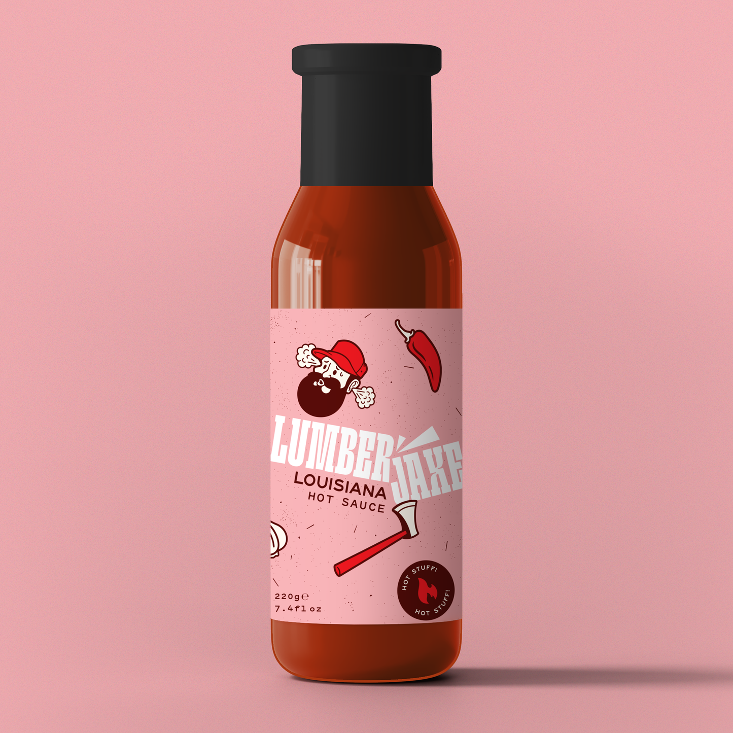 A single bottle of 'Lumberjaxe Louisiana Hot Sauce' displayed against a solid pink background. The bottle has a black cap and a pink label featuring a bearded lumberjack character wearing a red hat, looking flustered with steam coming from his head. The design includes an illustration of a red chili pepper and an axe. The label highlights the sauce’s spiciness with a 'Hot Stuff!' badge and indicates a weight of 220g (7.4 fl oz).